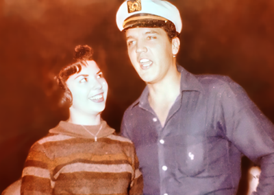 Elvis with skipper's hat next to Arlene Cogan-Bradley